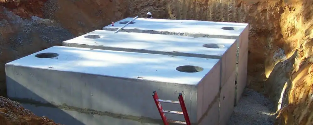 Septic tank installation site with a newly placed concrete tank in Portland, OR